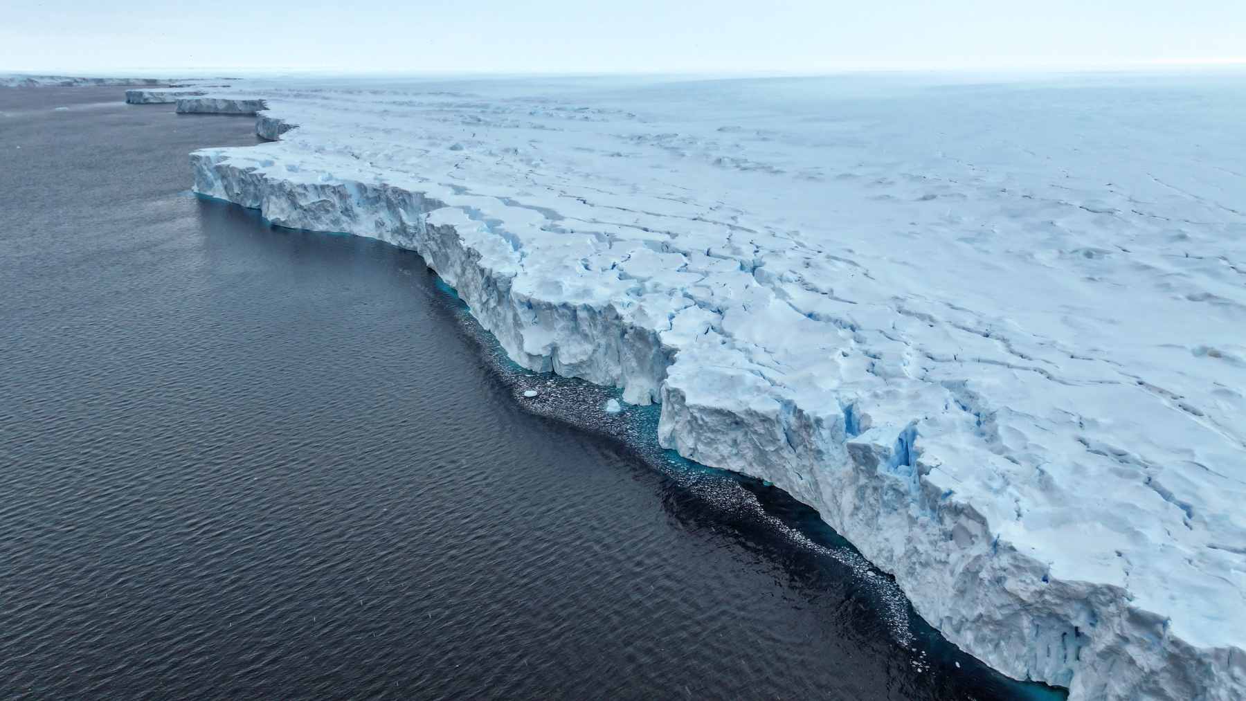 A yellow Argo profiling float being deployed into the Southern Ocean near the Antarctic ice edge.