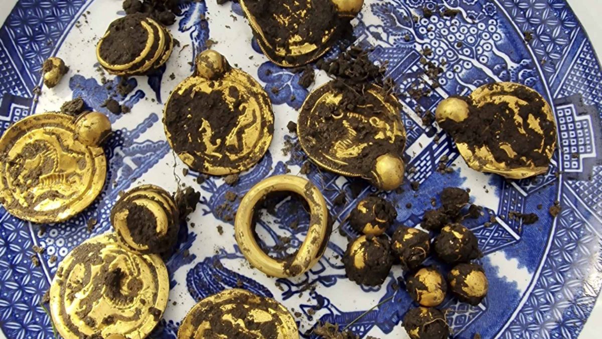Nine 6th-century gold bracteates and beads found on Rennesøy island, Norway, showcasing intricate Migration Period craftsmanship.