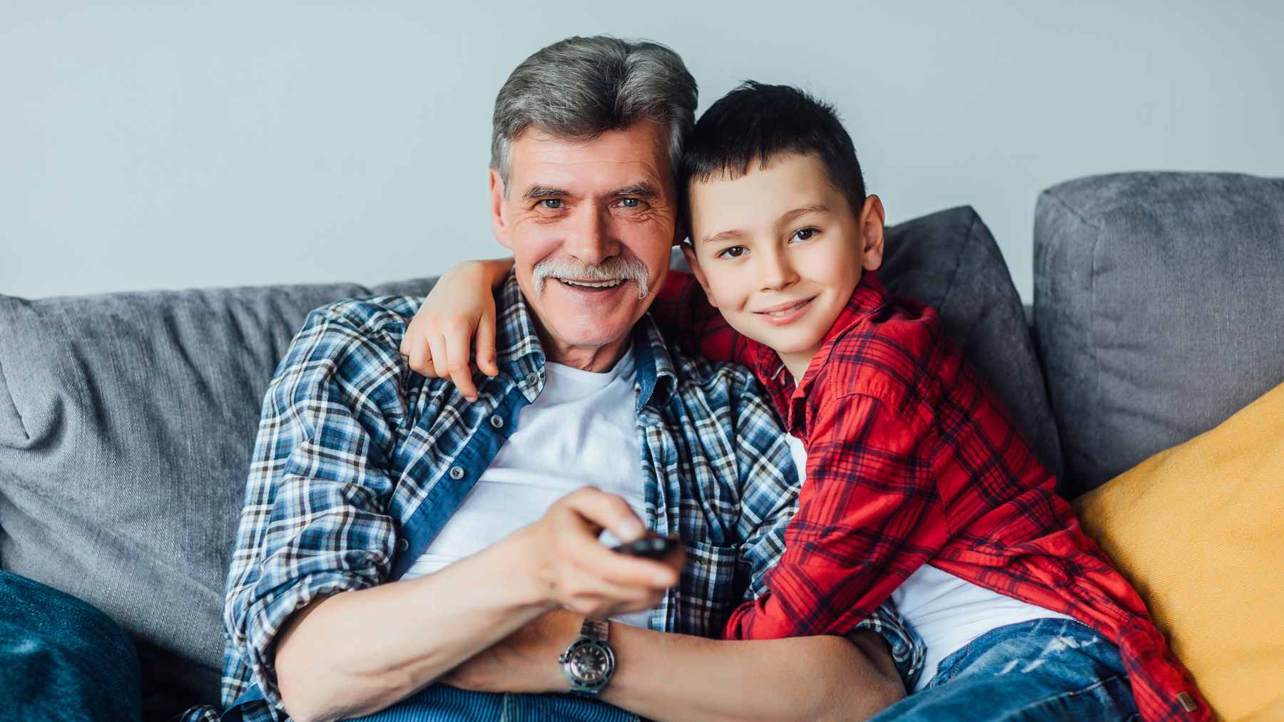 An older father in his early sixties playing with his young children, illustrating the demographic of parents eligible for Social Security child benefits.