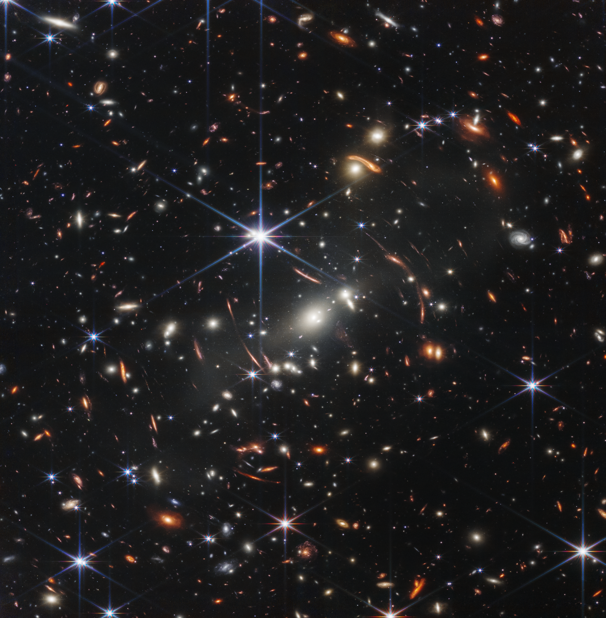 A deep space image from the James Webb Space Telescope showing the tiny, red-shifted smudge of galaxy MoM-z14 in the COSMOS field.