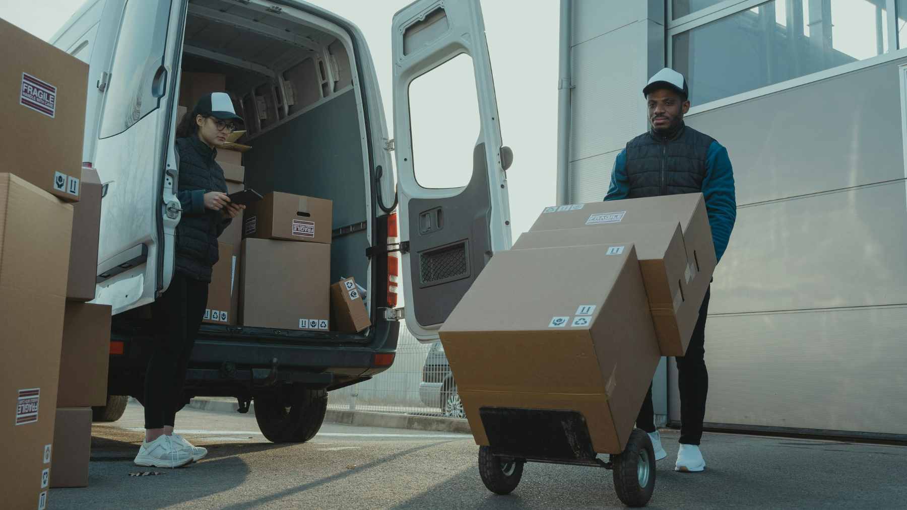 A collection of undelivered Amazon packages and boxes stacked in a residential area, representing the recovered stolen goods.