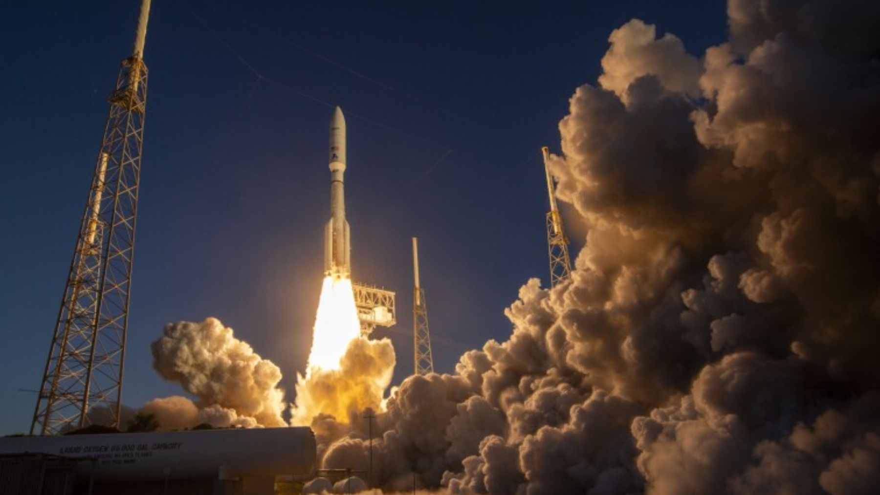 A long-exposure photograph of the night sky showing streaks caused by a constellation of Amazon Leo internet satellites passing overhead.