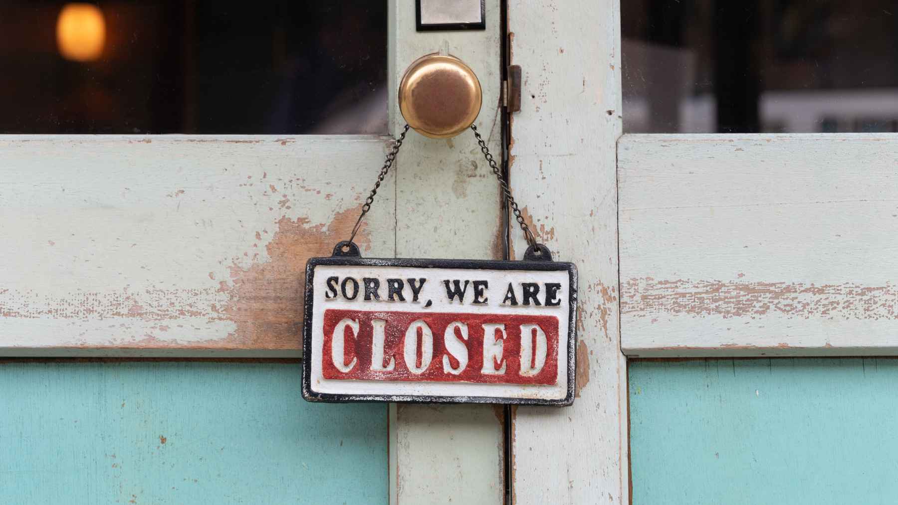A “Sorry, we are closed” sign hanging on a door, symbolizing restaurant shutdowns as Arby’s quietly closes locations nationwide.