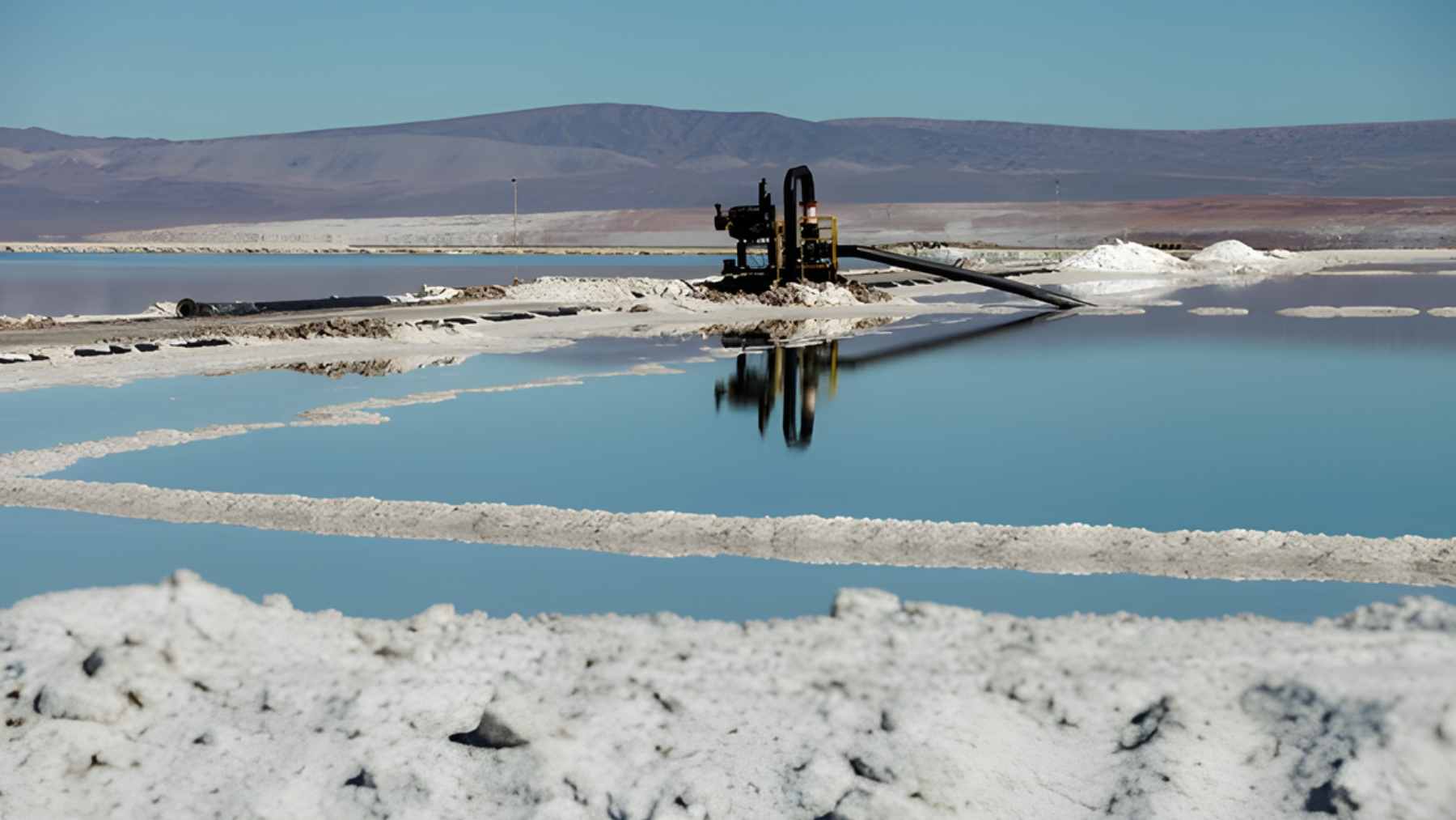 An aerial view of the vast turquoise evaporation ponds at the Salar de Atacama lithium deposit in northern Chile.