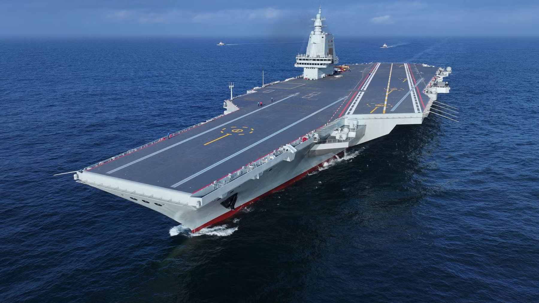 The Chinese aircraft carrier Fujian (hull number 18) docked at a naval port in Sanya during its official commissioning ceremony.