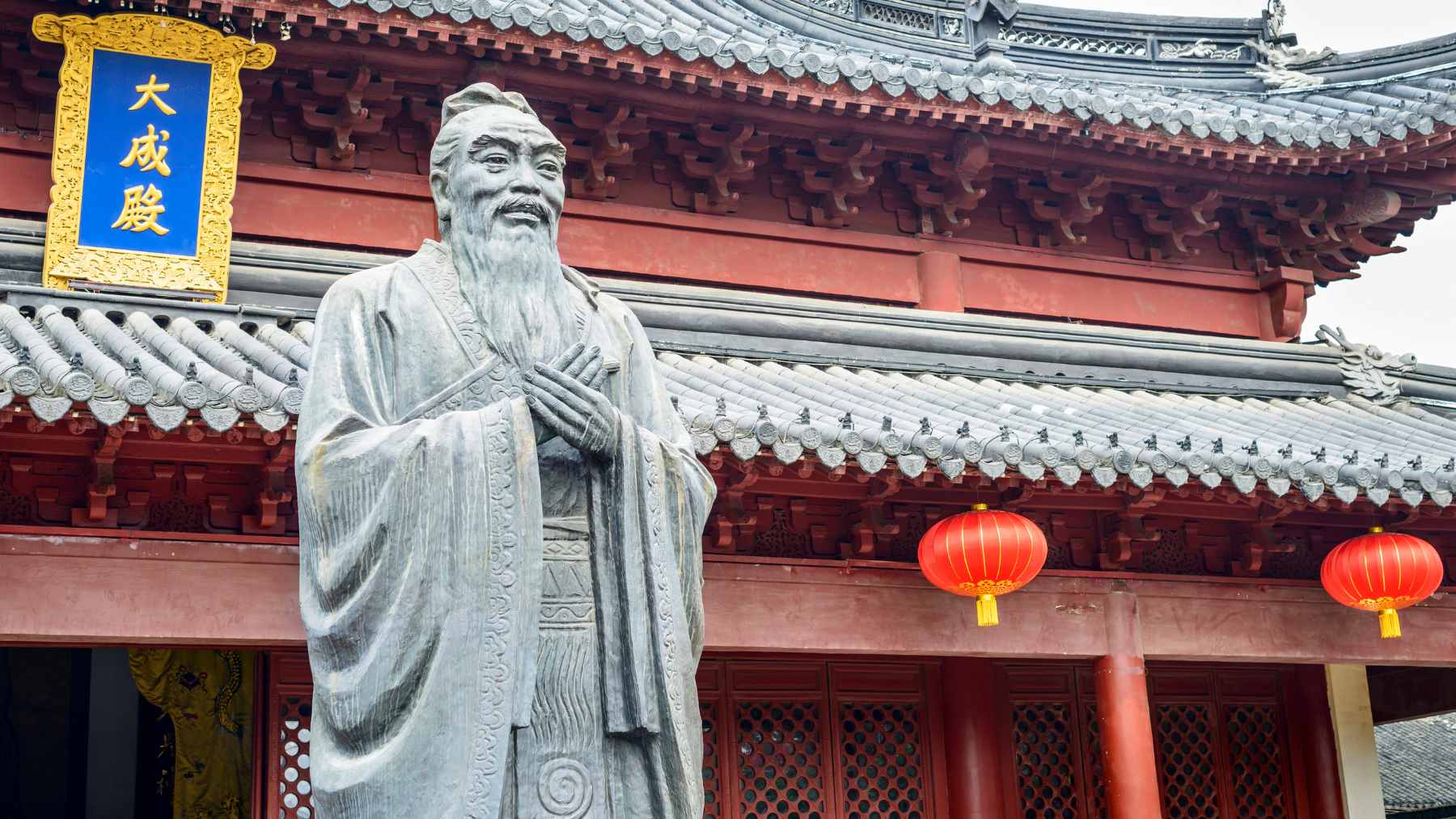 A conceptual illustration of the Confucian proverb "The man who moves a mountain begins by carrying away small stones," showing a path built from small rocks.