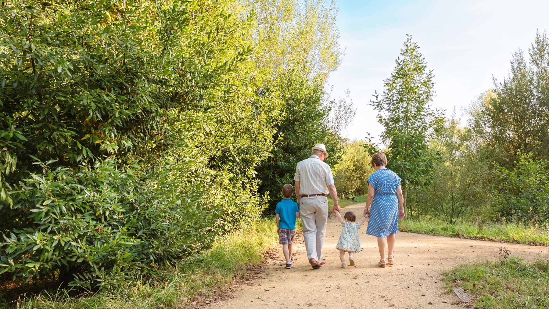 An older woman smiling while helping her young grandson with a colorful puzzle on a living room floor, illustrating the cognitive engagement of grandparenting.