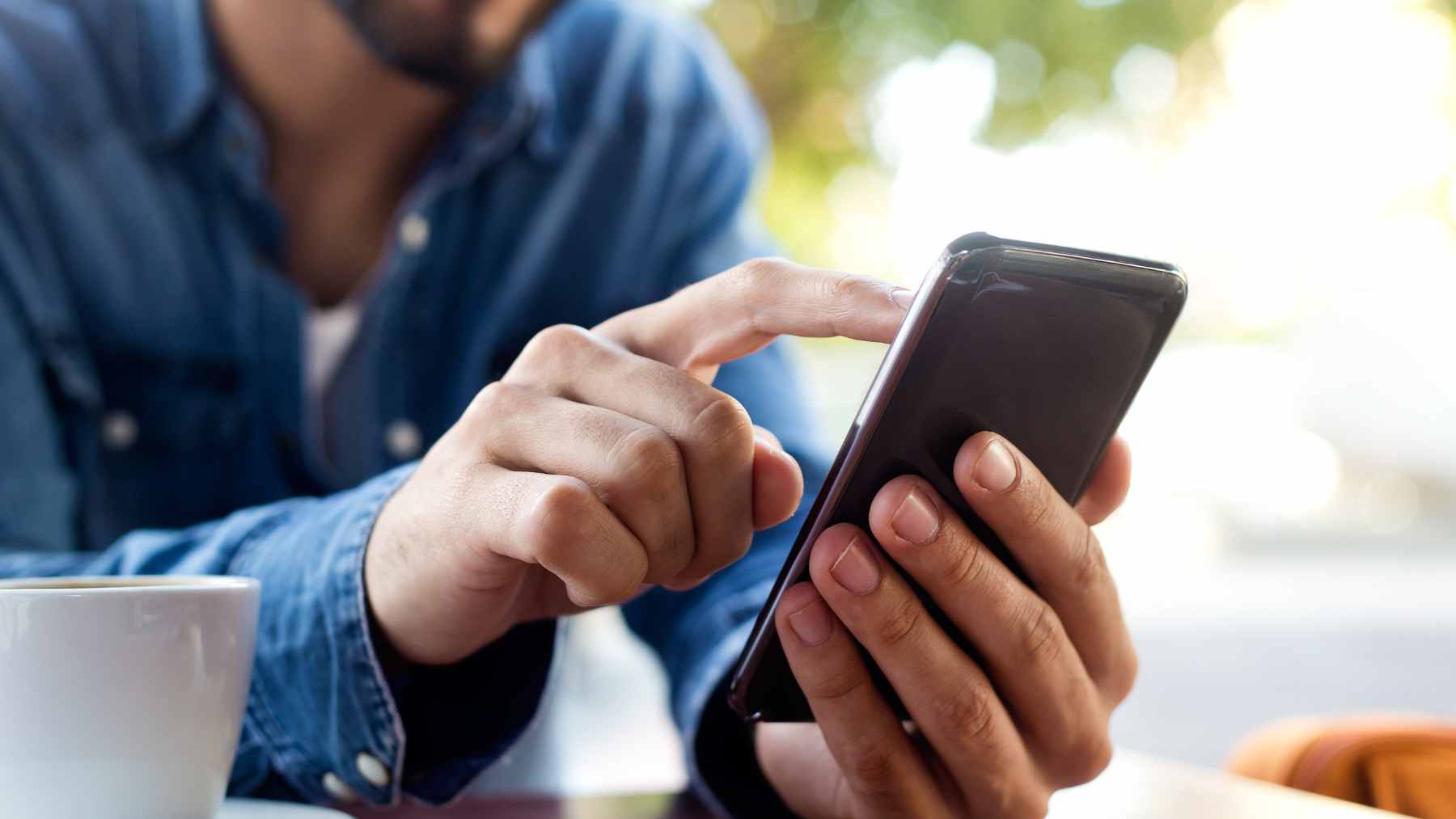 A close-up of a smartphone screen showing a green indicator dot in the top right corner of the status bar.
