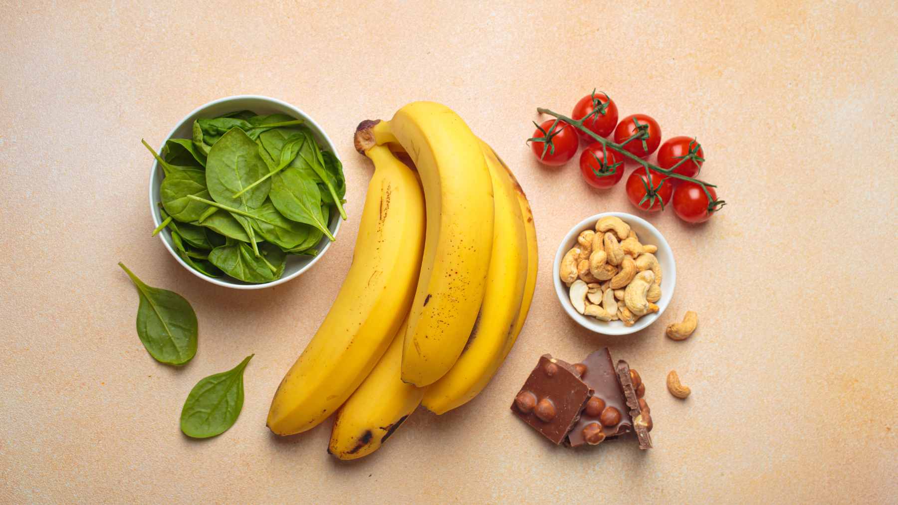 A variety of magnesium-rich foods including leafy greens, nuts, and legumes displayed on a kitchen counter.