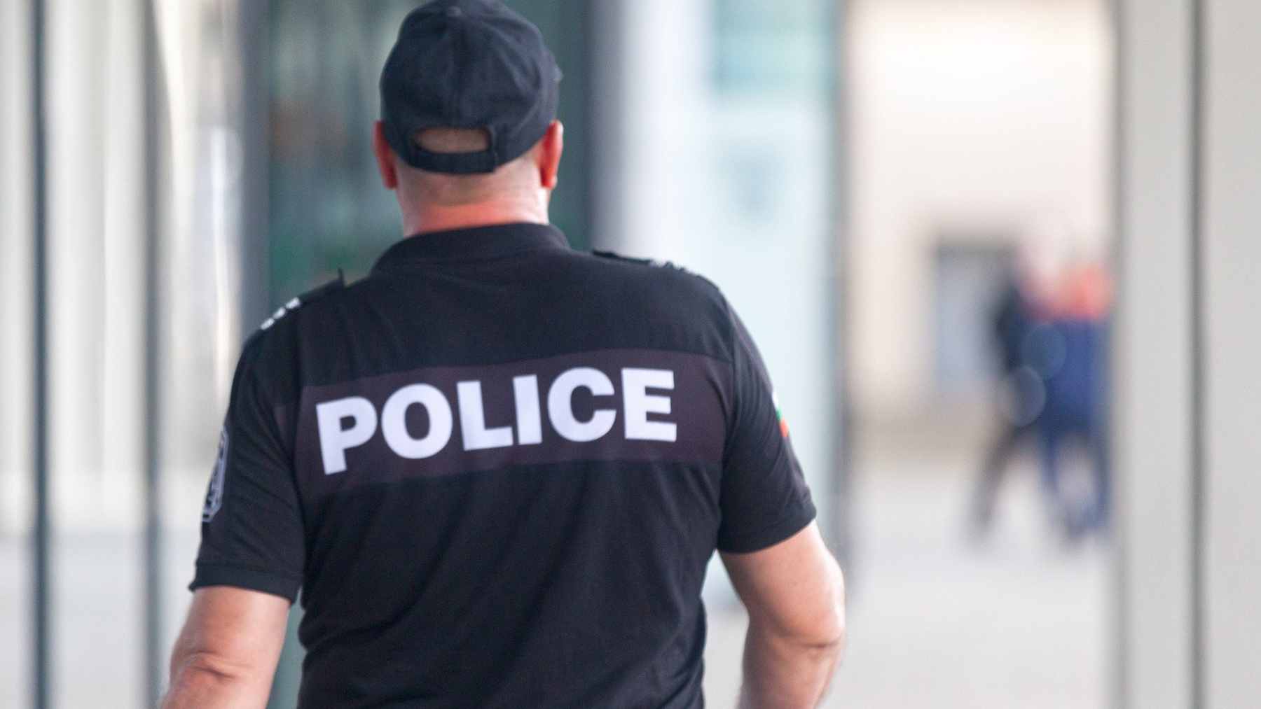 A stack of official Oakland City Auditor reports and budget documents sitting on a desk, highlighting the $57 million police overtime spending gap.