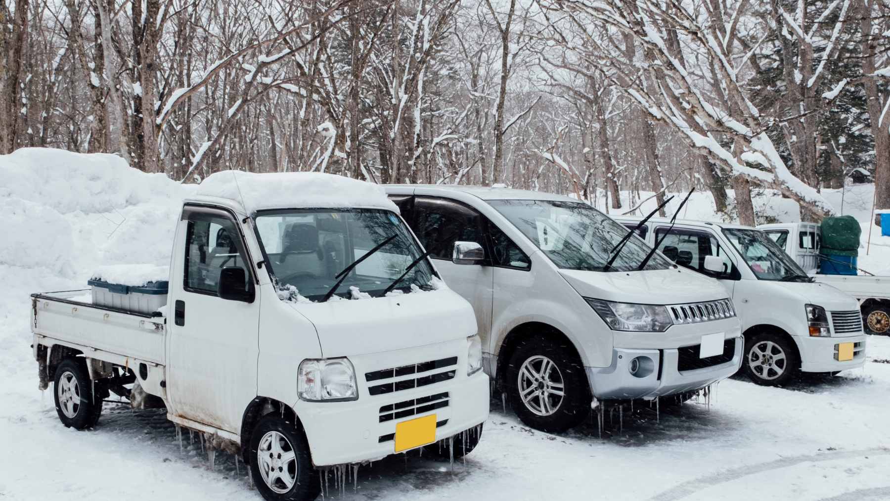 A USPS mail carrier shoveling heavy snow around a buried delivery truck in Fairfield, Ohio, during Winter Storm Fern.