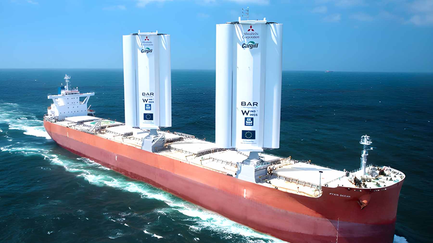 The Pyxis Ocean cargo ship at sea featuring two vertical 37.5-meter rigid WindWings installed on its deck to harness wind power.