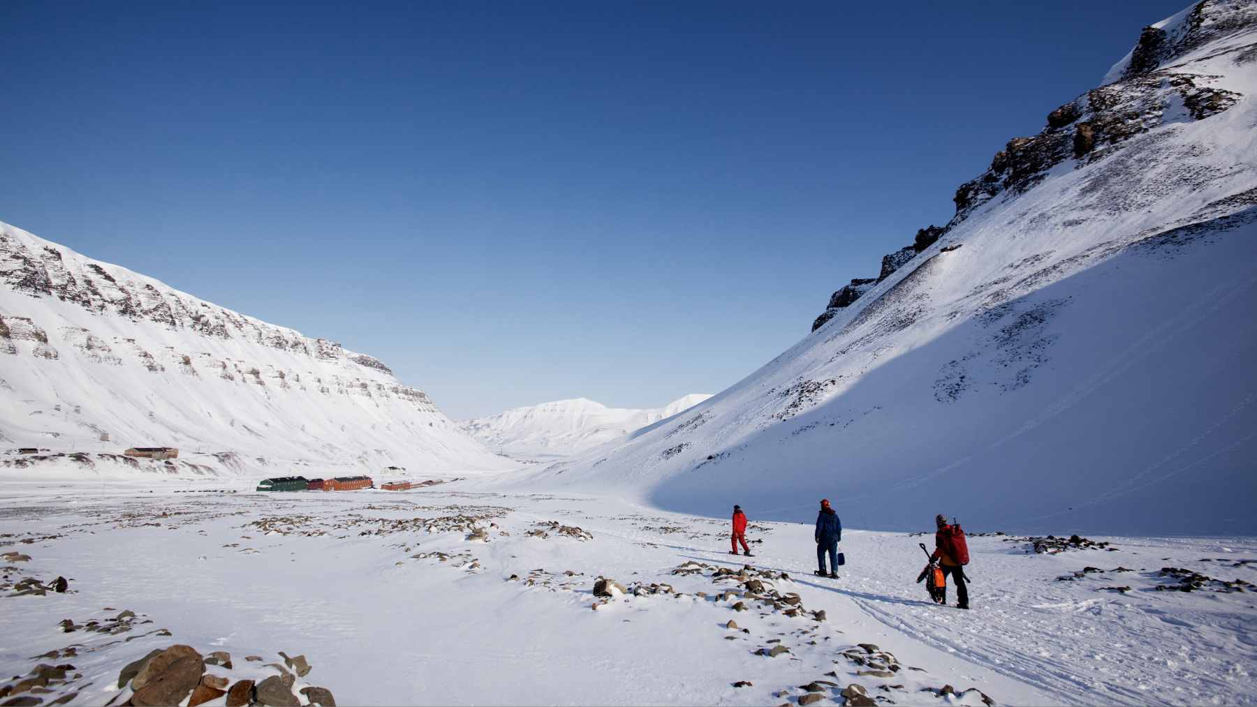 A historical map of the 17th-century Svalbard archipelago alongside an illustration of a wooden whaling shore station in the snow.