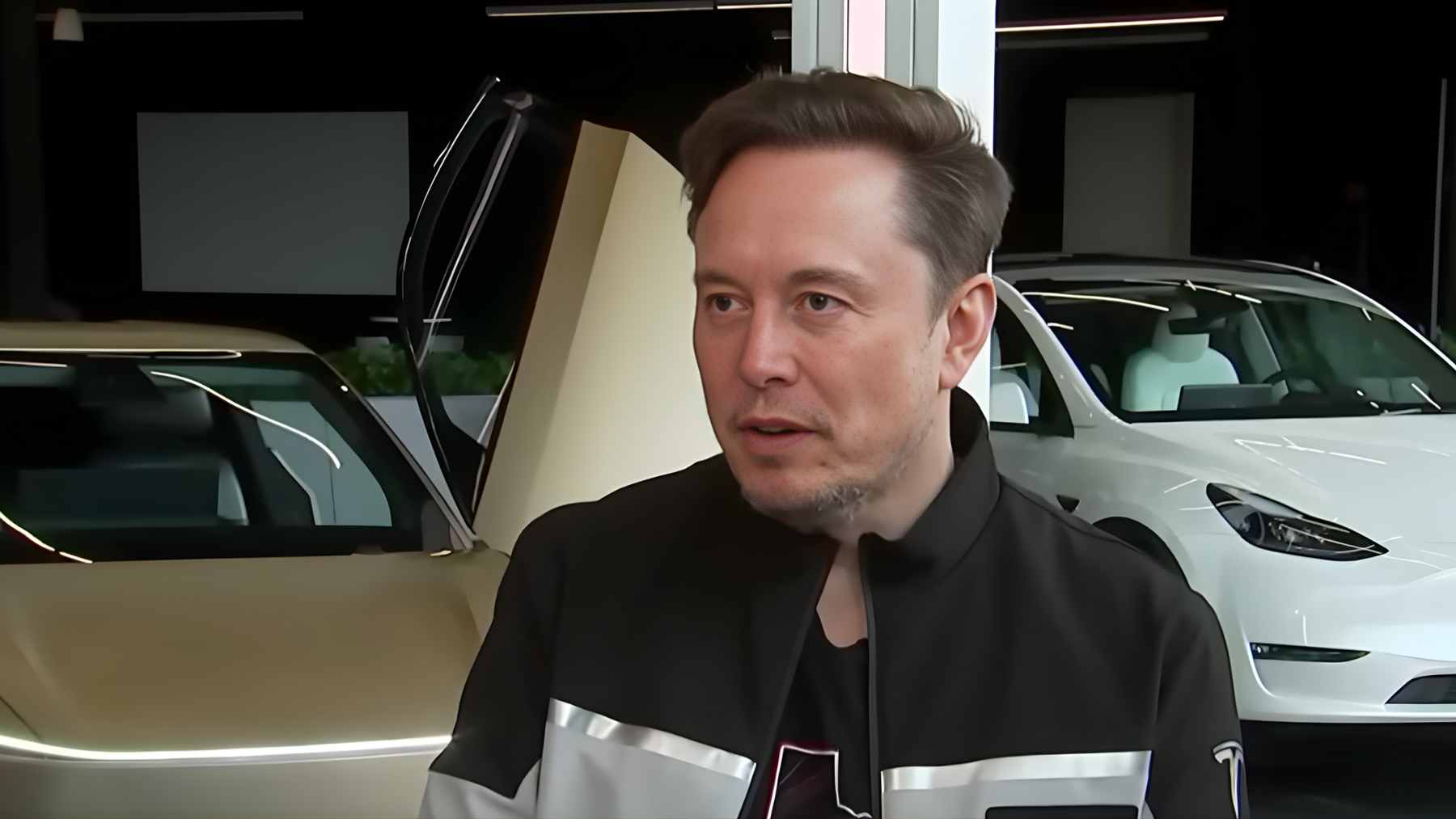 Elon Musk presenting the Tesla Optimus humanoid robot at a shareholder meeting in Austin.