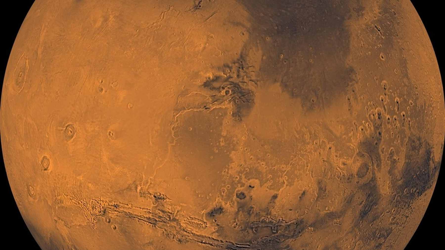 A high-resolution view of a massive Martian dust storm covering the Red Planet's surface, illustrating the atmospheric reactions described in the study.